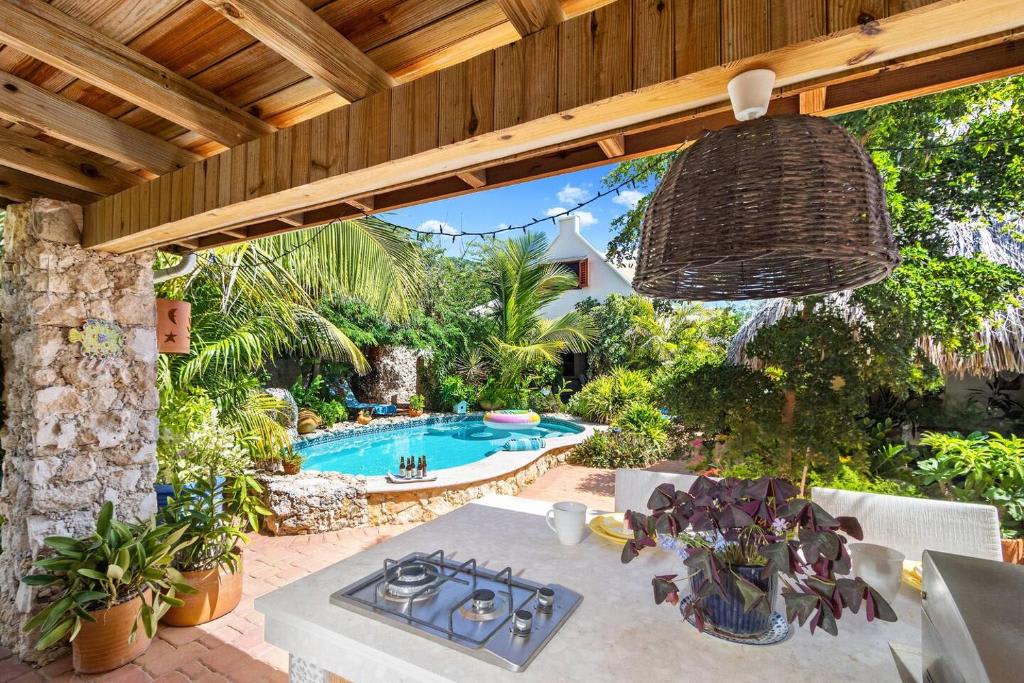 Covered outdoor kitchen overlooking the pool