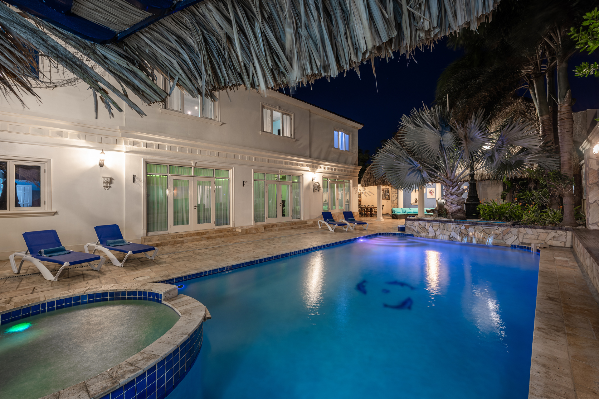 Villa pool illuminated at night